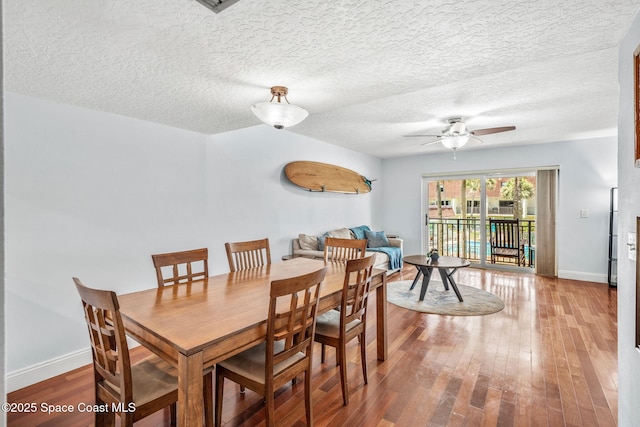 170 Paradise Blvd Unit 17013, Melbourne, FL 32903 - dining room featuring a ceiling fan, wood finished floors, and a textured ceiling