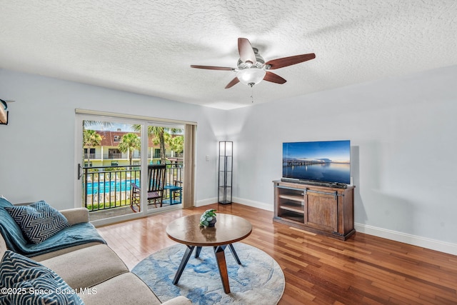 170 Paradise Blvd Unit 17013, Melbourne, FL 32903 - living room with a ceiling fan, wood finished floors, and a textured ceiling