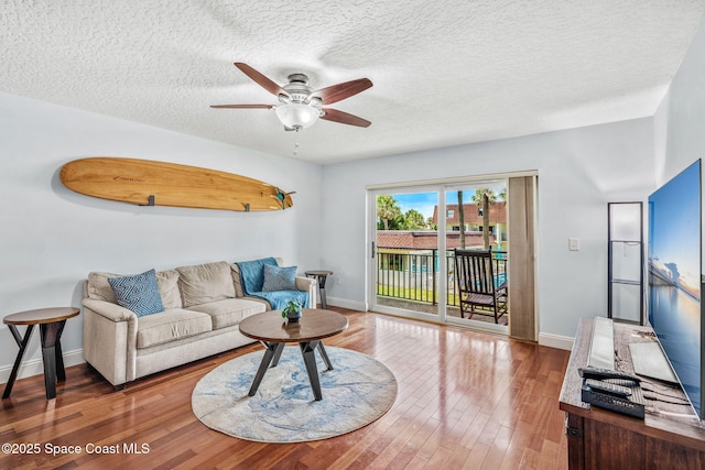 170 Paradise Blvd Unit 17013, Melbourne, FL 32903 - living area featuring a ceiling fan, wood finished floors, and a textured ceiling