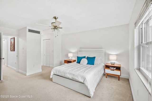 170 Paradise Blvd Unit 17013, Melbourne, FL 32903 - carpeted bedroom with multiple windows, a ceiling fan, and a closet