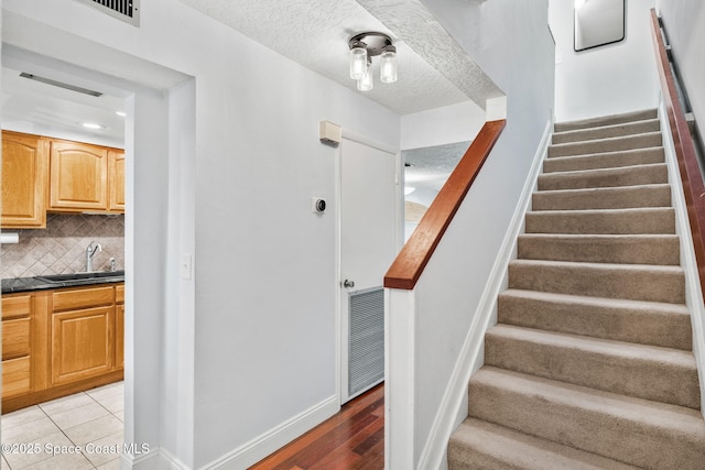 170 Paradise Blvd Unit 17013, Melbourne, FL 32903 - staircase with a textured ceiling and baseboards
