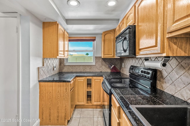 170 Paradise Blvd Unit 17013, Melbourne, FL 32903 - kitchen with black appliances, decorative backsplash, tile countertops, light tile patterned floors, and recessed lighting