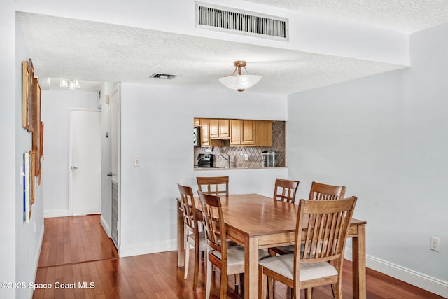 170 Paradise Blvd Unit 17013, Melbourne, FL 32903 - dining area with wood finished floors and a textured ceiling