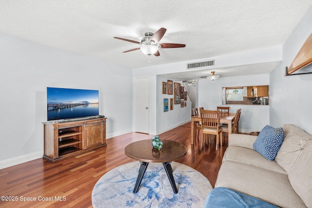 170 Paradise Blvd Unit 17013, Melbourne, FL 32903 - living room featuring ceiling fan, wood finished floors, and a textured ceiling