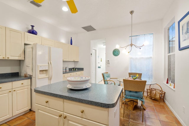 kitchen with ceiling fan with notable chandelier, decorative light fixtures, and a center island