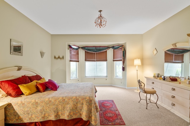 carpeted bedroom with multiple windows