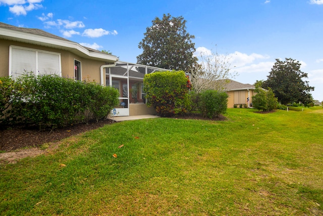 view of yard featuring a lanai and a patio area