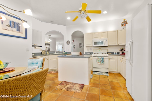 kitchen with white cabinets, white appliances, ceiling fan, and a center island