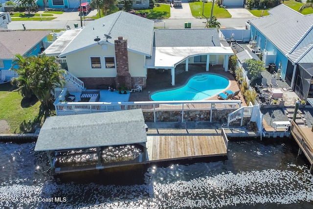 1730 E Central Ave, Merritt Island, FL 32952 - back of property with a fenced backyard, a patio area, stairs, and a water view