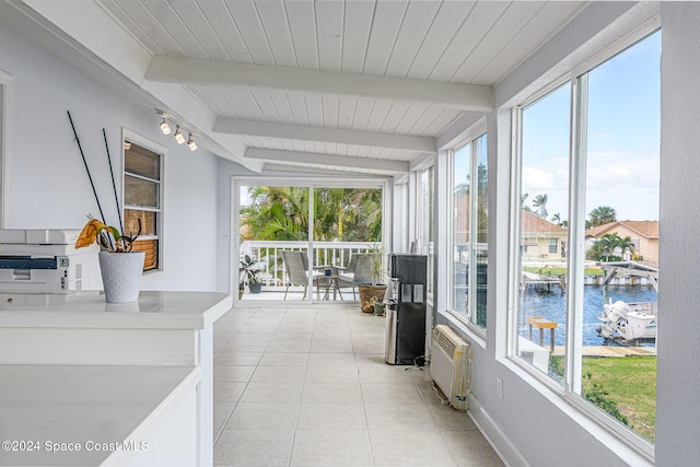 sunroom with a water view and vaulted ceiling with beams