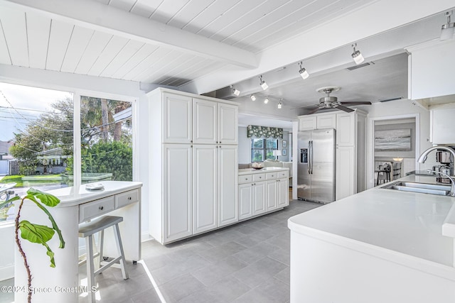 1730 E Central Ave, Merritt Island, FL 32952 - kitchen with stainless steel fridge, a sink, healthy amount of natural light, a ceiling fan, and wooden ceiling with exposed beams