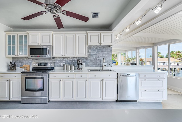 1730 E Central Ave, Merritt Island, FL 32952 - kitchen with stainless steel appliances, a sink, rail lighting, and light countertops