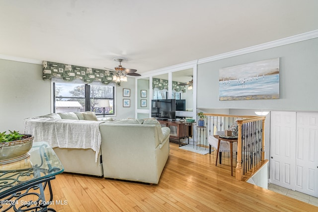 living room featuring hardwood / wood-style flooring, ceiling fan, and crown molding