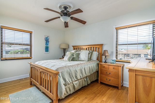 bedroom with light hardwood / wood-style floors and ceiling fan