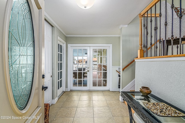 foyer entrance with crown molding and french doors