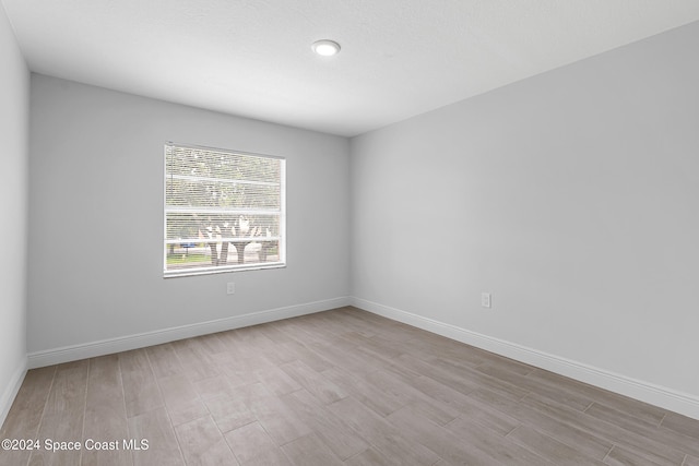 spare room with light wood-type flooring