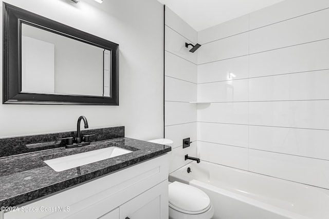 full bathroom with tiled shower / bath, toilet, and vanity