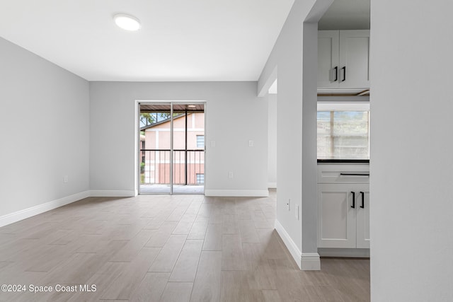 empty room with light hardwood / wood-style flooring