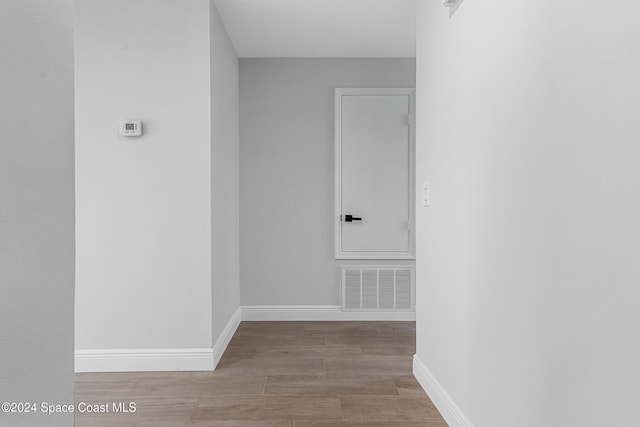 hallway with light hardwood / wood-style flooring