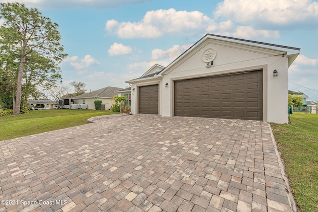 view of front of property with a garage and a front lawn