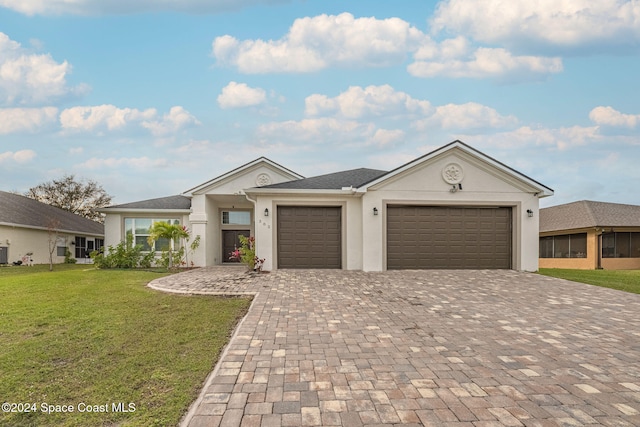 view of front of property featuring a garage and a front yard