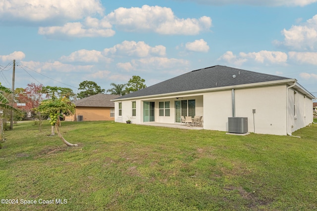 back of house featuring a patio, a lawn, and cooling unit