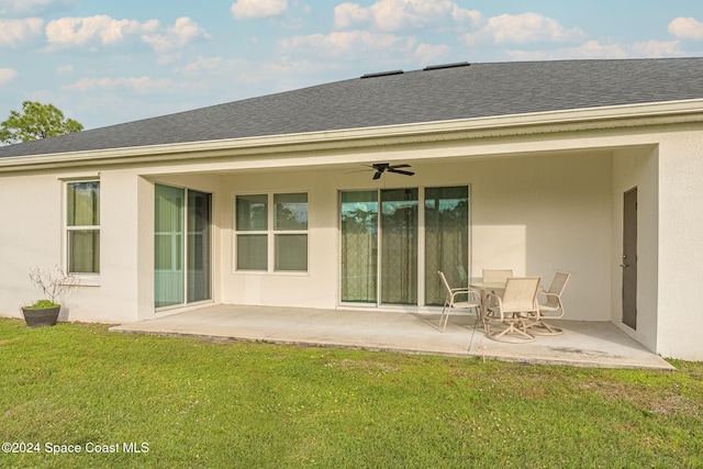 back of house with ceiling fan, a yard, and a patio