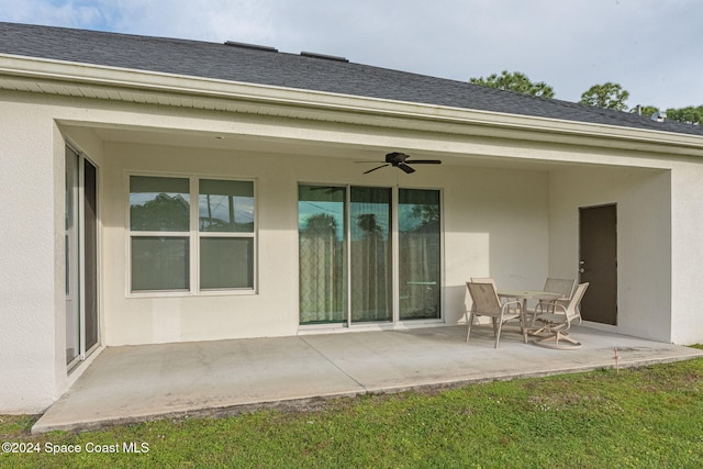 back of house featuring a patio area, a lawn, and ceiling fan