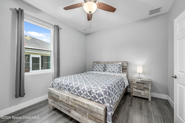 bedroom with dark wood-type flooring and ceiling fan