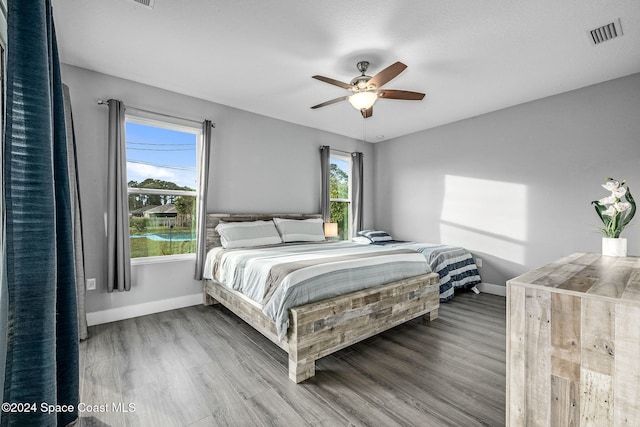 bedroom with wood-type flooring and ceiling fan