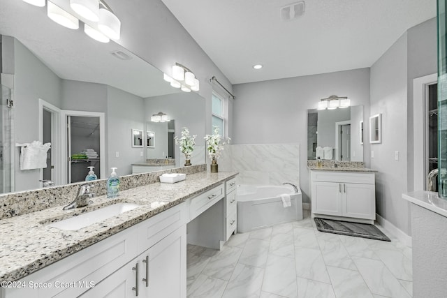 bathroom with independent shower and bath, vanity, and a textured ceiling