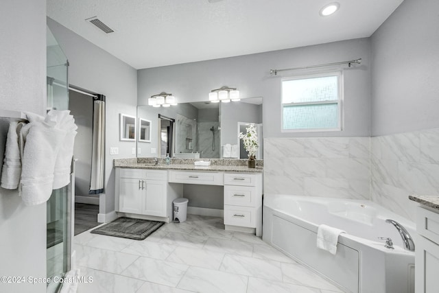 bathroom with shower with separate bathtub, vanity, and a textured ceiling