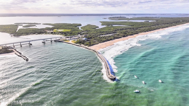 birds eye view of property featuring a beach view and a water view