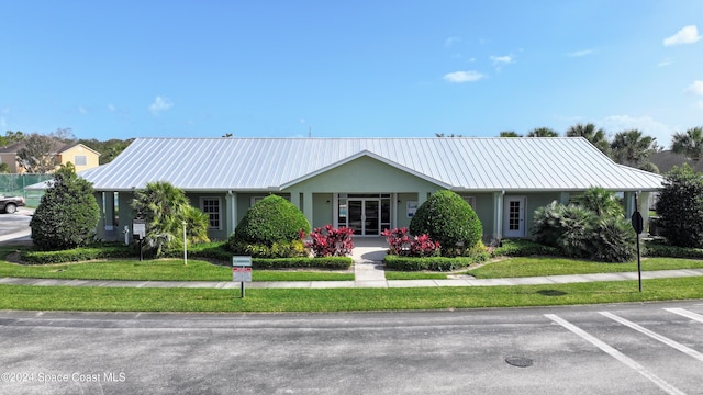 ranch-style home with a front lawn