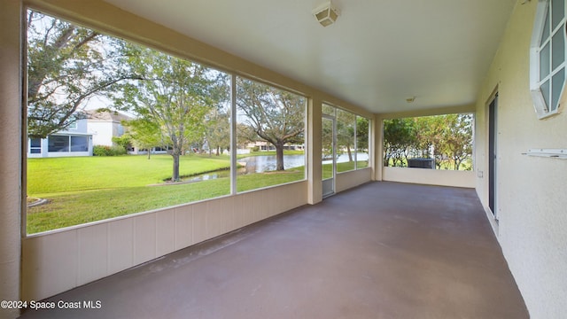 unfurnished sunroom featuring a wealth of natural light and a water view