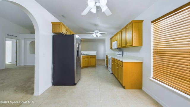 kitchen with white appliances, ceiling fan, and light tile patterned floors