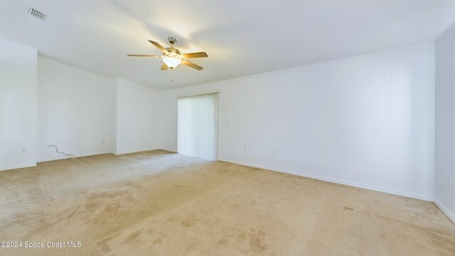 carpeted empty room with ceiling fan