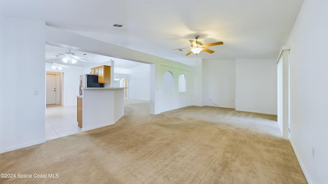 unfurnished living room featuring light carpet