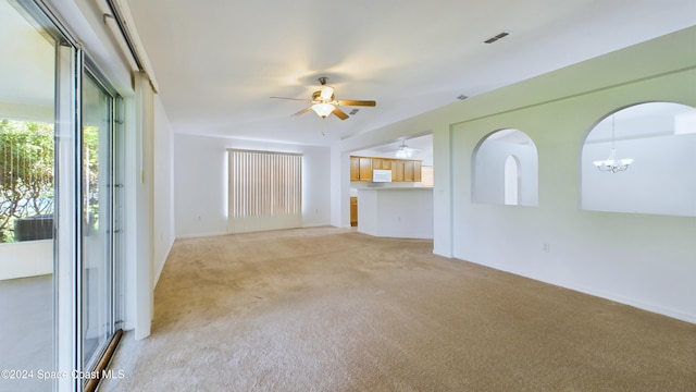 unfurnished living room featuring light colored carpet and ceiling fan with notable chandelier