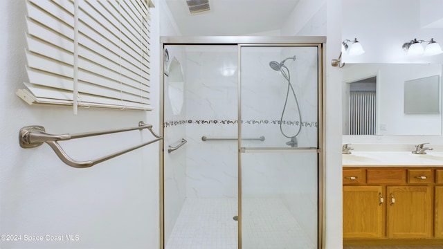 bathroom with walk in shower and vanity