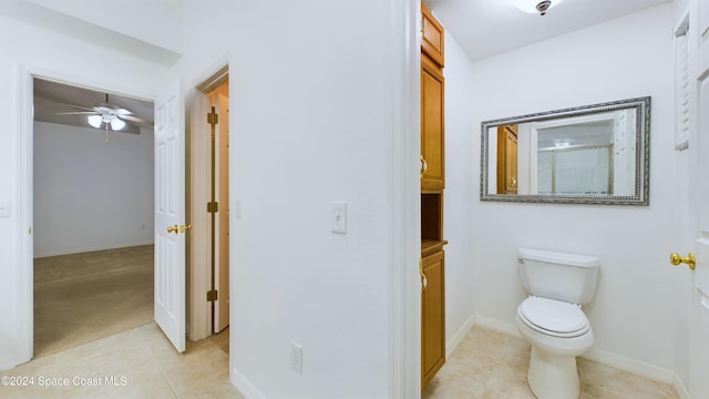 bathroom featuring walk in shower, ceiling fan, vanity, tile patterned floors, and toilet