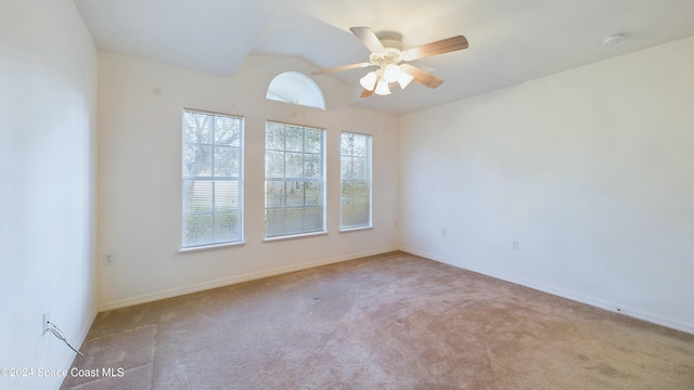 unfurnished room with lofted ceiling, light carpet, and ceiling fan