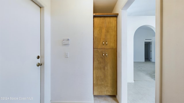 hallway featuring light tile patterned floors