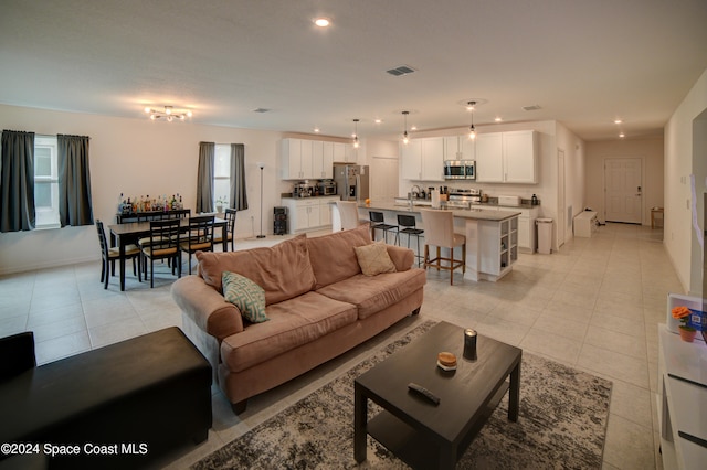 living room with light tile patterned flooring and sink