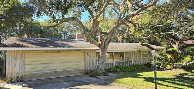 ranch-style home with a front yard and a garage