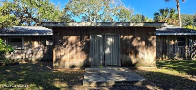 view of outbuilding featuring a lawn