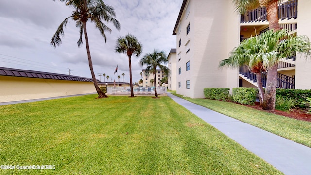 view of yard with a balcony