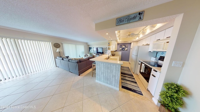 kitchen featuring white cabinets, kitchen peninsula, a textured ceiling, light tile patterned floors, and white appliances