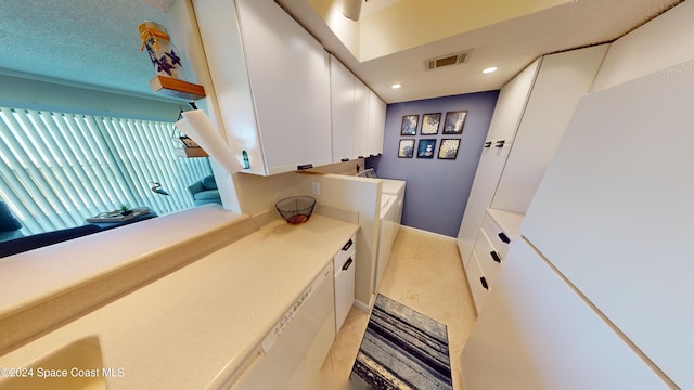 bathroom with tile patterned flooring and a textured ceiling