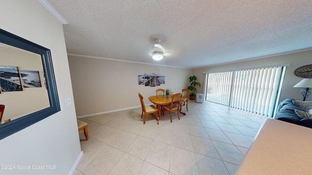 dining space featuring ceiling fan, light tile patterned floors, and crown molding